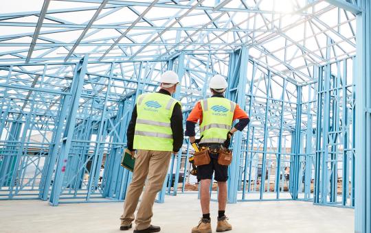 Builders standing in a truecore steel framed house