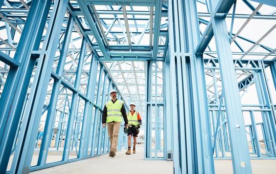 Tradies walking through a LGS blue framed home